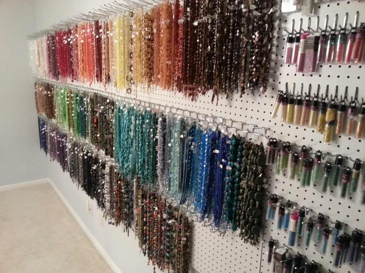 Wall of organized beads and materials sorted by color