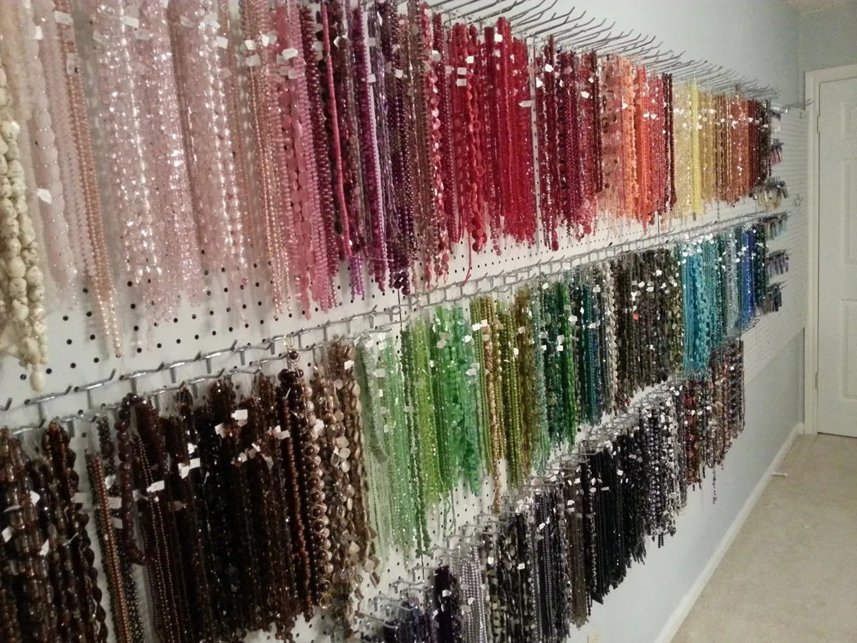 Extensive bead collection on pegboard wall display
