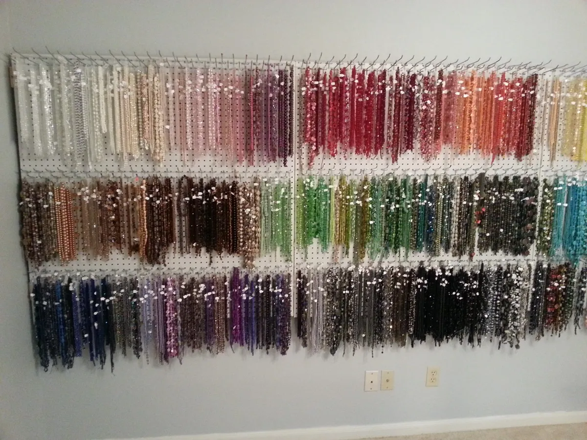 Full wall of beads, stones, and materials organized by type and color