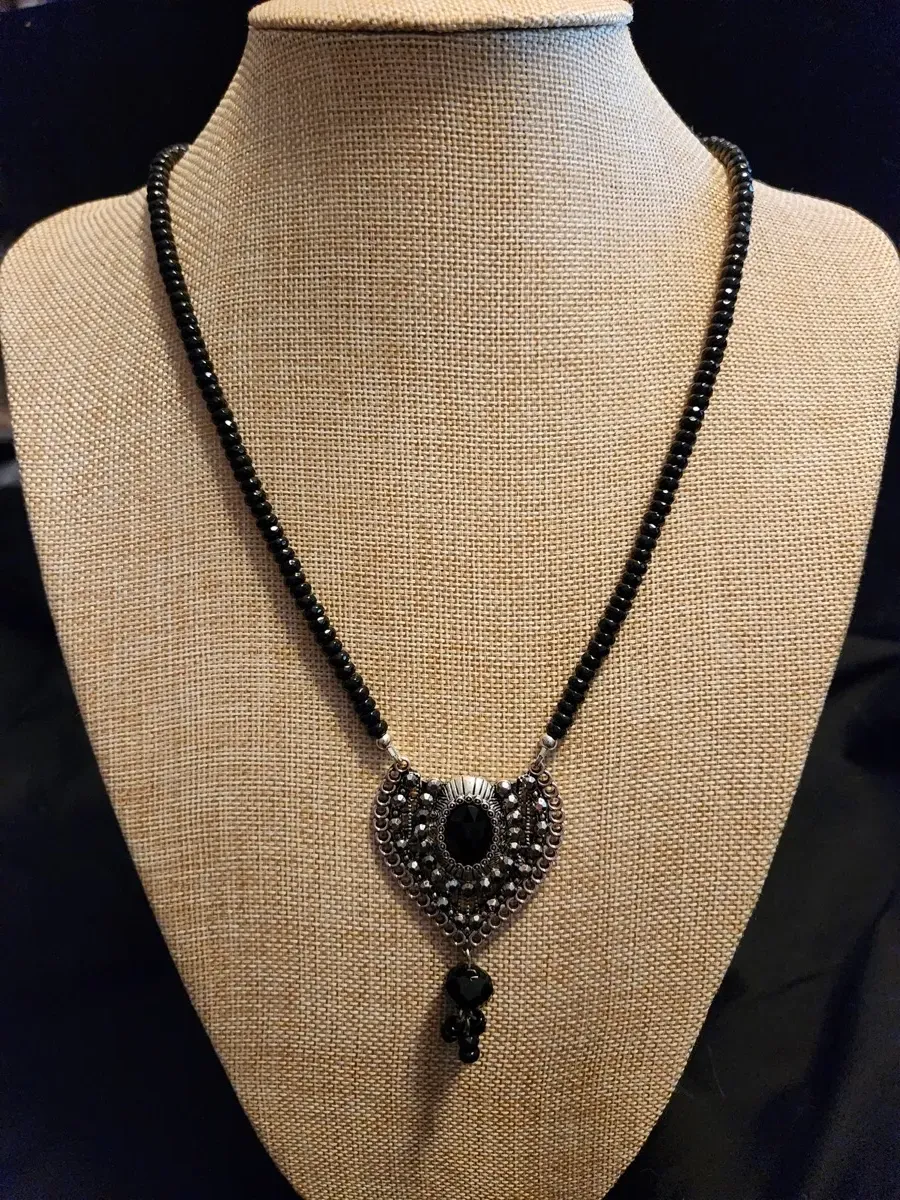 Black beaded necklace with ornate center medallion