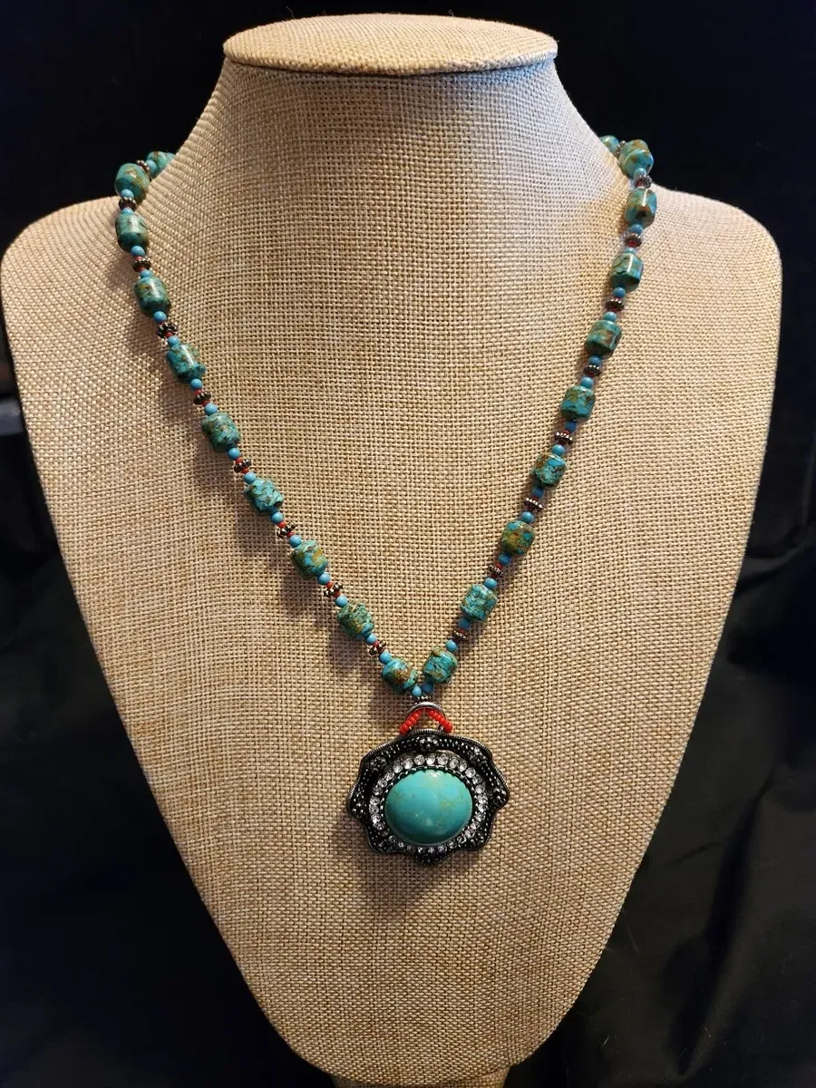 Handcrafted turquoise beaded necklace with decorative pendant
